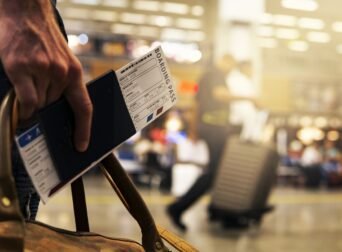 Traveler planning award flight bookings with credit cards and passport.